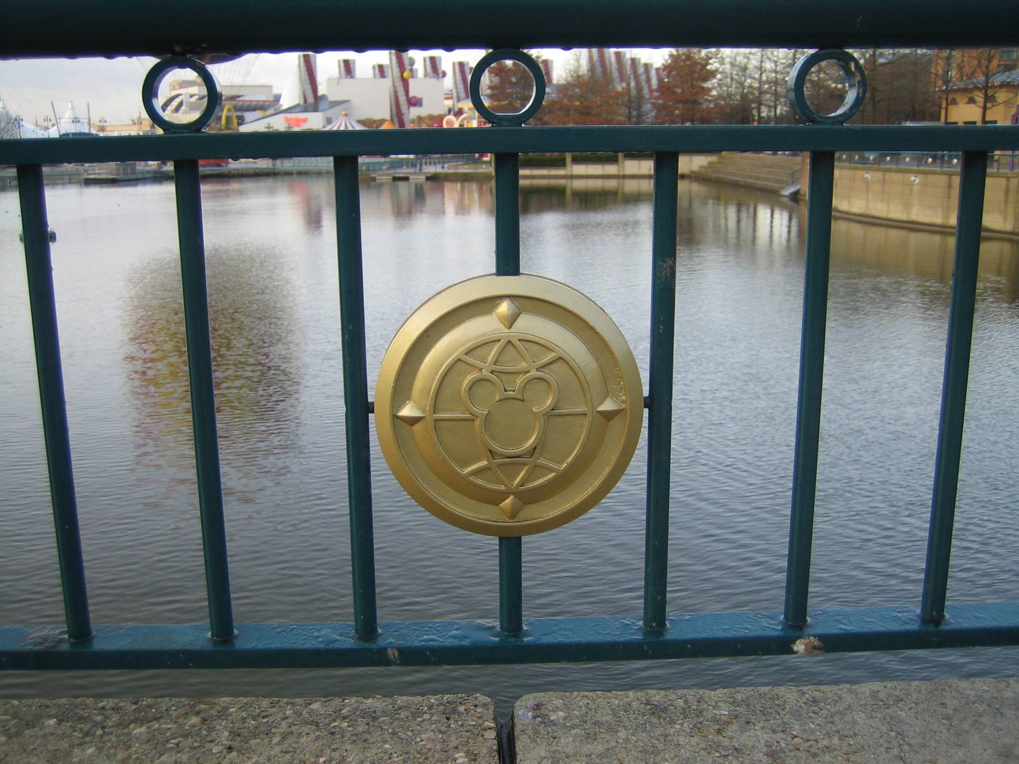 Mickey Mouse in handrail on bridge over Lake Disney