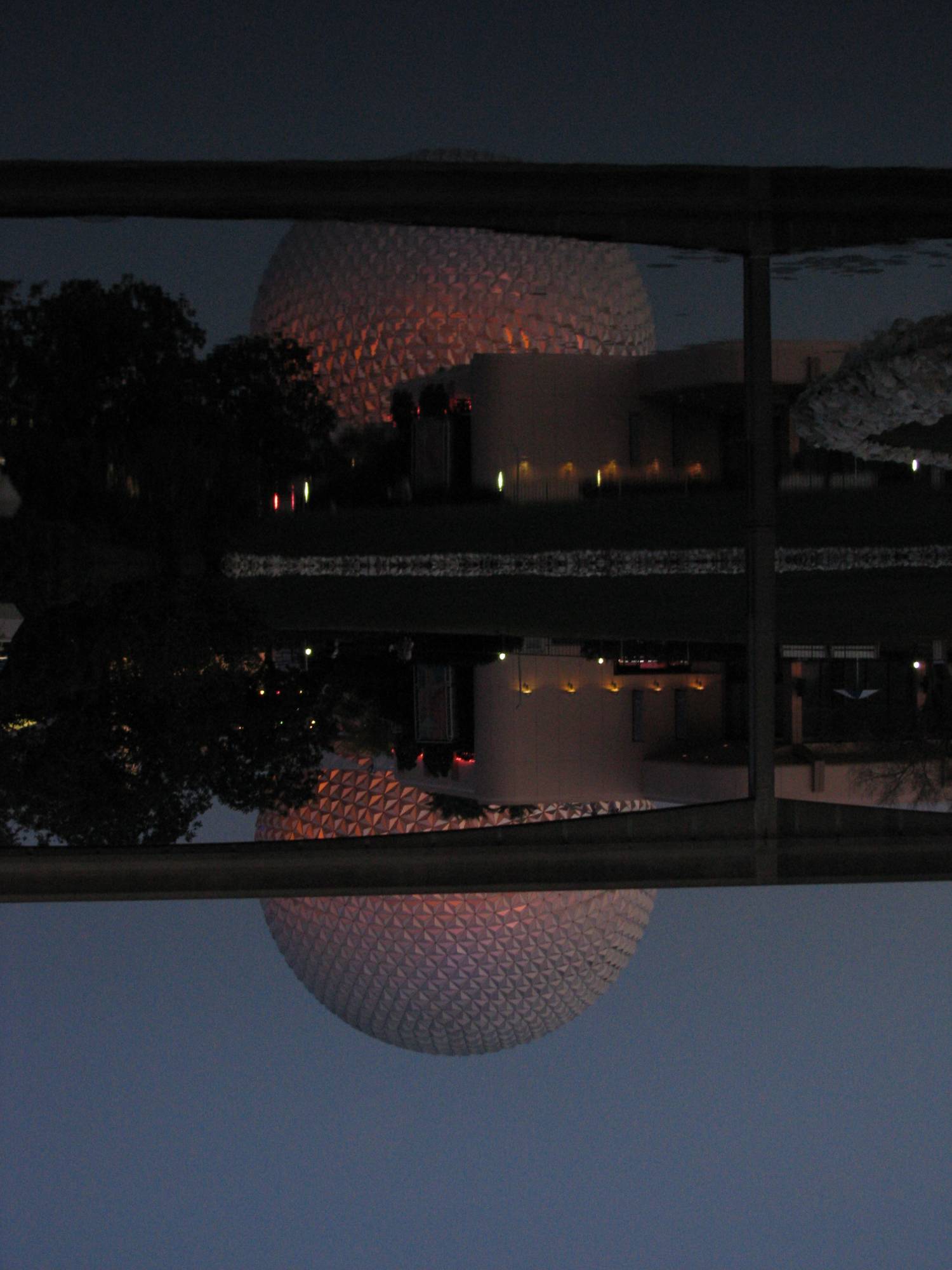 Reflection of the monorail and geodesic sphere at Epcot