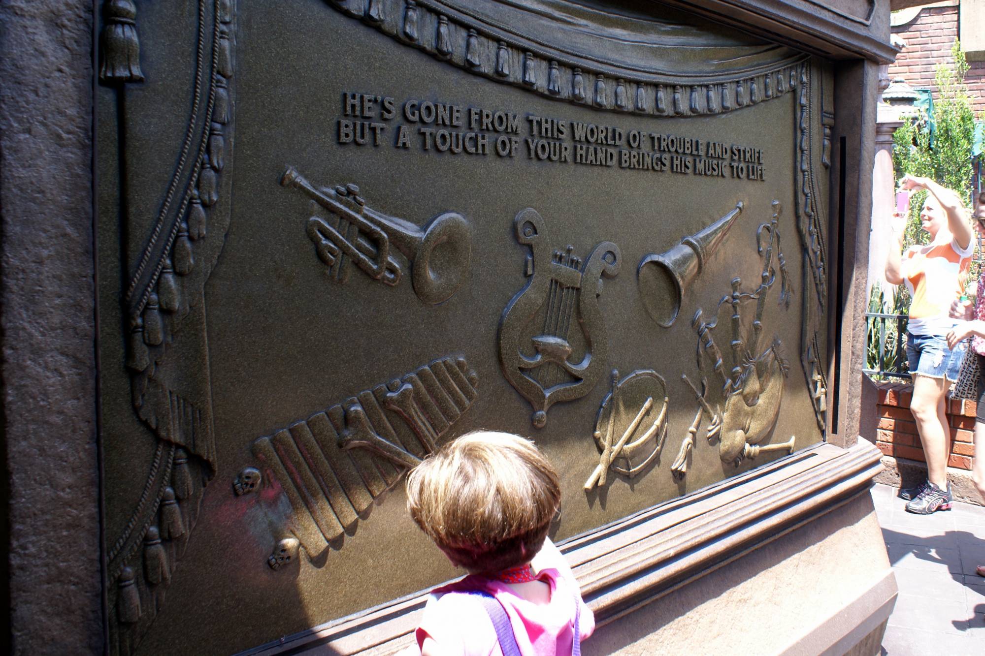 Stefanie Playing Music in Interactive Queue at Haunted Mansion