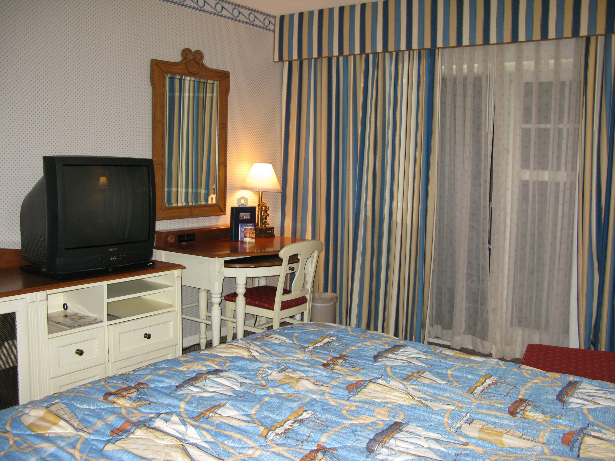 Yacht Club guest room with king bed entertainment center